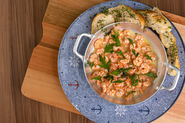 Shrimp in lemon sauce and portion of bread to accompany