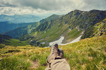 Feet trekking boots and mountains landscape on background Travel Lifestyle adventure vacations