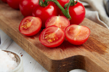 Fresh red cherry tomatoes on white wooden background