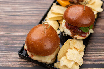 three mini hamburgers with potato chips