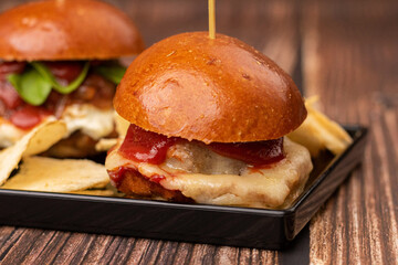 three mini hamburgers with potato chips