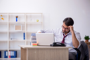 Young male employee working in the office