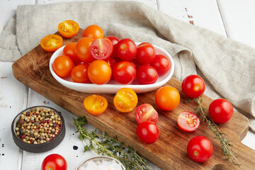 Fresh red cherry tomatoes on white wooden background