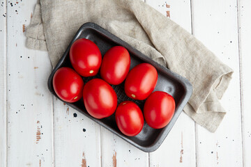 Fresh red tomatoes, close-up of fresh, ripe tomatoes on wooden background