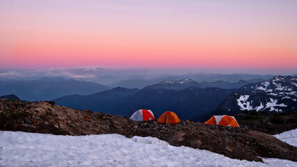 Colorful tents on cliff with scenic expansive  view of mountains at sunset.  Backcountry camp. Rocky mountain. Colorado. United States © aquamarine4