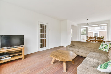 View of white living room in minimal style with television,sofa , wooden octagon table