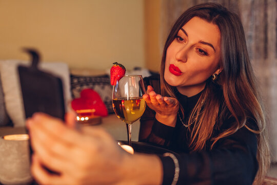 Valentines Day online remote celebration due to covid coronavirus lockdown at home. Video chat with wine glass