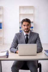 Young male employee working in the office