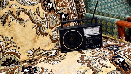 Portable transistor radio in a classic black case.