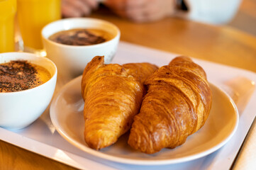 French breakfast with fresh baked croissants, coffee and orange juice
