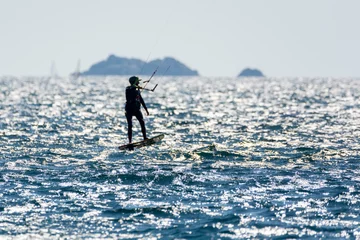 Foto op Aluminium Hyeres, Almanarre beach, France, July 10, 2021. Extreem water sport - wing foil, kite surfing, wind surfindg, windy day on Almanarre beach near Toulon, South of France © barmalini