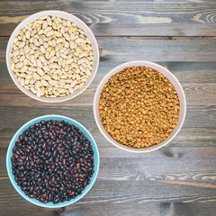 three ceramic bowls with various healthy grains. The concept of natural healthy food. Grains beans close up