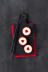 Creamy white chocolate mousse dessert with a jelly heart, in the form of round sweet sushi,...