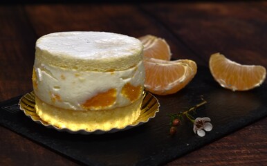 cake with tangerine on black board