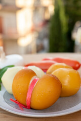 Cheese collection, variety of Italian cow milk cheese scamorza with Italian houses on background