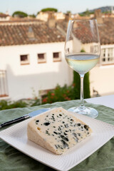 Cheese collection, semi-hard French blue cheese roquefort from Roquefort-sur-Soulzon, France served with sweet cold white french wine