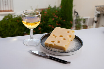 Cheese collection, semi-hard French cheese emmentaler with round holes made from cow milk served with sweet white wine