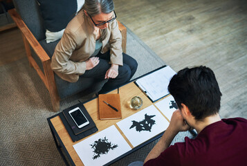 A way to scan the subconscious. Shot of a mature psychologist conducting an inkblot test with her patient during a therapeutic session. © Allistair/peopleimages.com