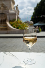 Drinking of brut champagne sparkling wine in street cafe in old central part of city Reims, Champagne, France