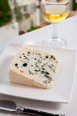 Cheese collection, semi-hard French blue cheese roquefort from Roquefort-sur-Soulzon, France served with sweet cold white french wine