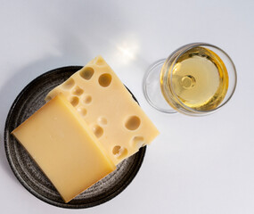 Cheese collection, hard French cheese comte made from cow milk with rind in Franche-Comte regio and emmentaler cheese, France, served with white wine