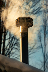 Warm air can be seen in morning light as it escapes the stove pipe during a very cold day in Upstate NY.