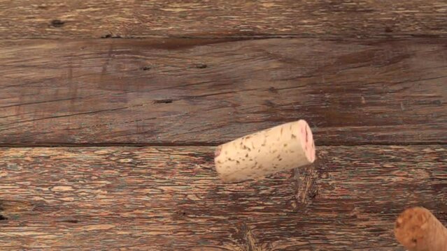 Falling wine corks on old wooden vintage boards. Slow