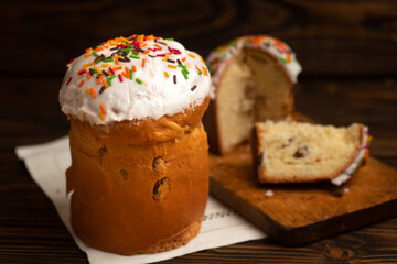 Easter russian traditional orthodox cakes kuliches on a vintage white cloth napkin on wooden boards
