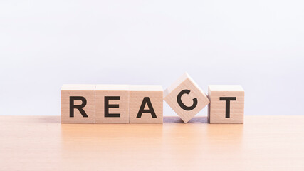 react - words from wooden blocks with letters, of inform brief concept, yellow background