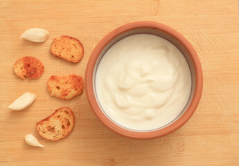 Sour cream in a wooden bowl. Farm organic product