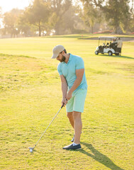 male golf player on professional golf course. golfer in cap with golf club. people lifestyle.