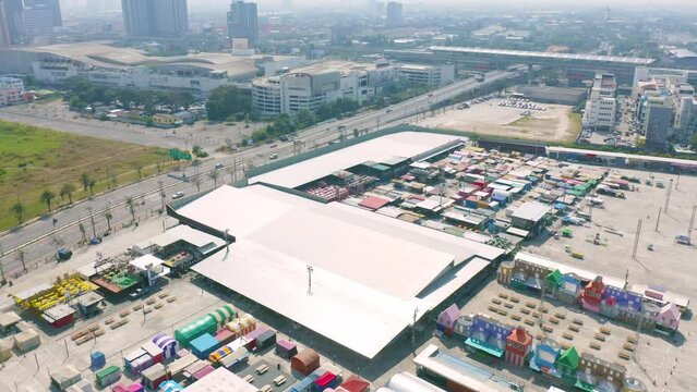 Aerial top view of Night Market people walking street, Colorful tents in the train of Ratchada at Bangkok city, Thailand. Retail shops