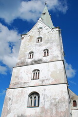 Fototapeta na wymiar Dobele lutheran church and blue sky with clouds.