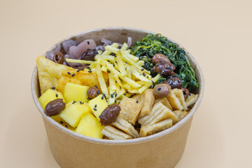 Vegeterian seafood bowl with smoked salmon, shrimp, avocado in take out paper container. Close up, copy space, top view, background.