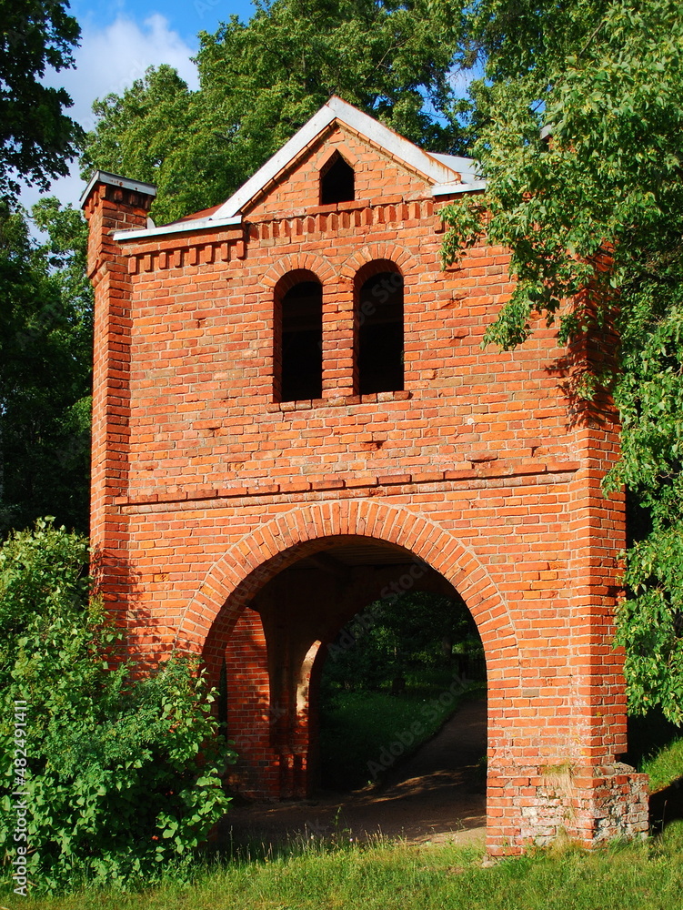 Poster red brick bell tower in sunny summer day