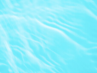 Ripple water texture on blue pool background. Shadow of water on sunlight. Mockup for product, spa or travel background. Marble blue water surface as wallpaper background