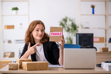 Young woman working in box delivery service