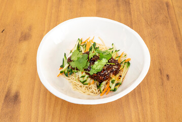 Zha jiang mian is a Beijing cuisine dish consisting of thick wheat noodles topped with a mixture of fried minced pork and fermented soybean paste