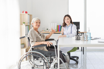 old Asian patient talk with female doctor and show thumb up sign with hand together, elderly health check up, happiness hospital