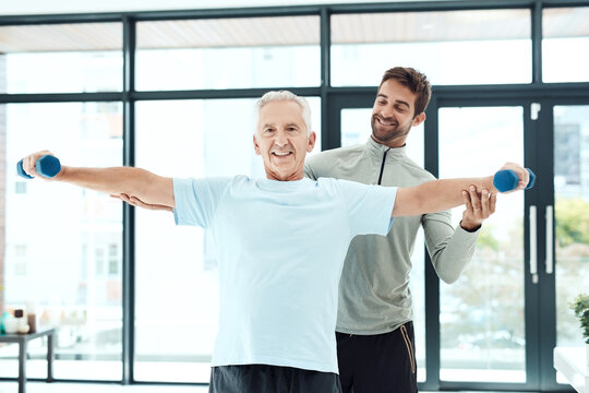 I'm working on being more independent. Shot of a friendly physiotherapist helping his senior patient work out with weights.