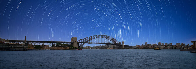 Startrails  Star trails Sydney Harbour Australia turquoise colours of the bay and high rise offices of the City in the background