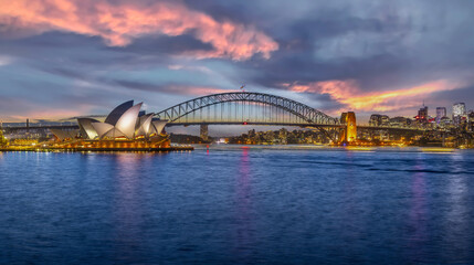 Fototapeta na wymiar Sydney Harbour Australia at Sunset with the turquoise colours of the bay and high rise offices of the City in the background