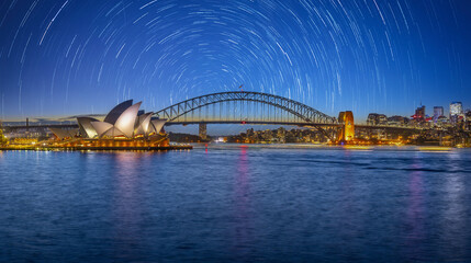 Sydney Harbour Australia with star trails startrails turquoise colours of the bay and high rise offices of the City