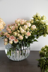 glass vase with bouquet of roses, floral arrangement with natural and fresh flowers, nature and gift for celebration, valentine, detail of petals, stem and leaves
