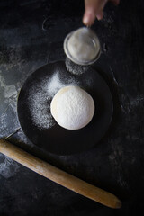 Mother kneads dough for her children