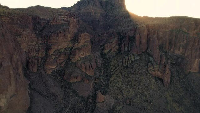 Aerial Following Hiking Trail Up Mountain to Reveal Sunrise on Flatiron Peak