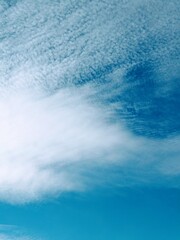 Fototapeta premium Cirrus cloud formations in the sky, vertical or portrait