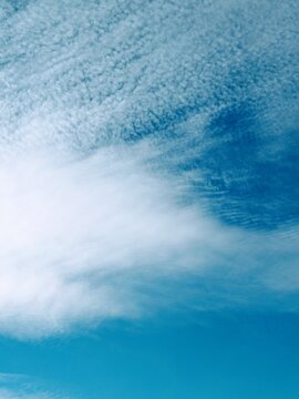 Cirrus cloud formations in the sky, vertical or portrait