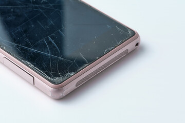 worn pink smartphone with broken screen