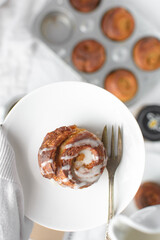 Morning buns on a white plate, glazed danish pastry on a white plate